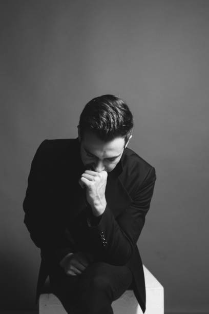 istock Studio portrait of a young man in a black blazer against plain studio background 1284218207