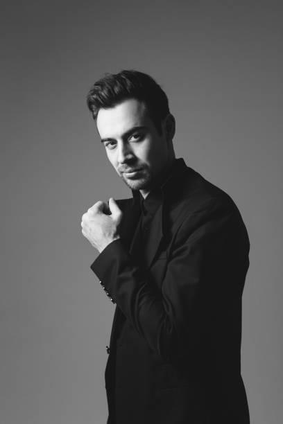 istock Studio portrait of a young man in a black blazer against plain studio background 1284218213