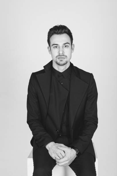 istock Studio portrait of a young man in a black jacket against plain studio background 1284218214