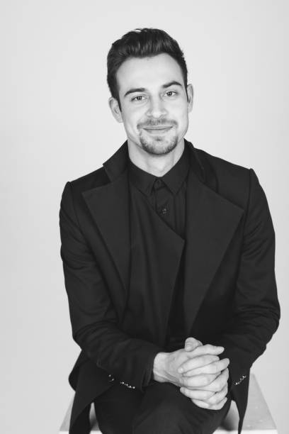 istock Studio portrait of a young man in a black jacket against plain studio background 1284218216