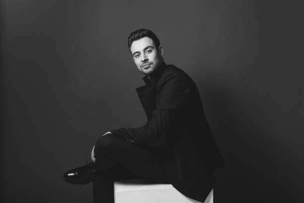 istock Studio portrait of a young man in a black blazer against plain studio background 1284218220