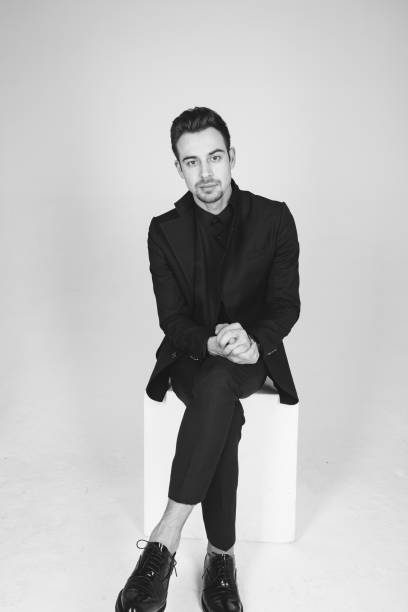 istock Studio portrait of a young man in a black jacket against plain studio background 1284218223