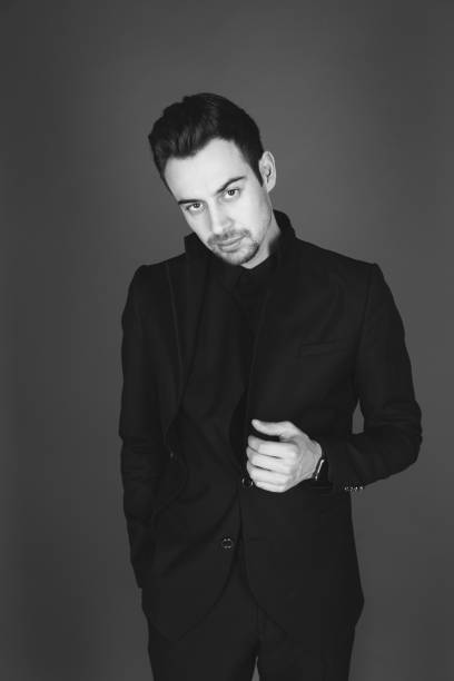 istock Studio portrait of a young man in a black jacket against plain studio background 1284218228