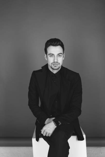 istock Studio portrait of a young man in a black jacket against plain studio background 1284218229