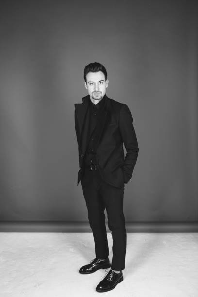 istock Studio portrait of a young man in a black jacket against plain studio background 1284218230
