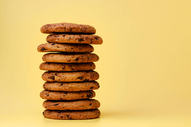 istock Pile of chocolate chip cookies on yellow backgreound 1284221415