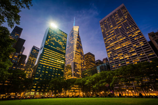 Skyscrapers in Midtown at night, seen at Bryant Park in Manhattan, New York. stock photo