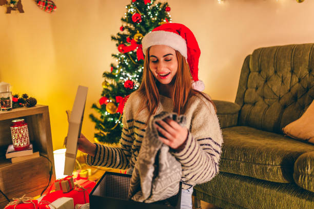 istock Woman opening her Christmas gift 1284223110