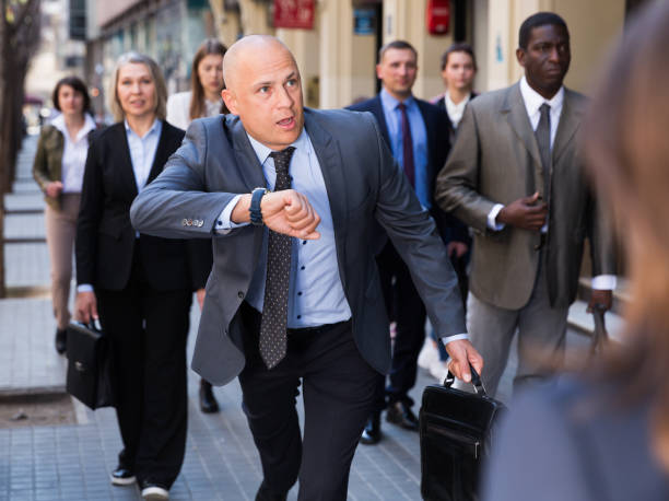 istock Stressed businessman checking time and running 1284223148