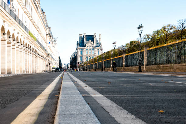Paris : rue de Rivoli during second wave and second coronavirus lockdown in autumn 2020. Usually crowded and congested, the street and the footpath under the arches are not busy. There are no more cars, but several cyclists ; many people stay in teleworking at home. Restaurants, cinema, museums... are closed. Paris, in France. November 5, 2020.