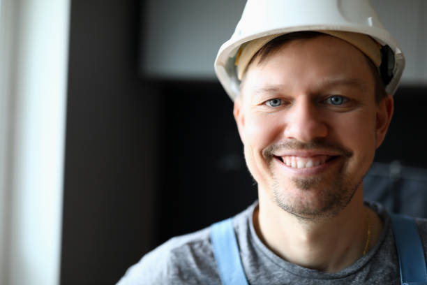 Close up face of builder in helmet. The staff is involved in the construction of a new house