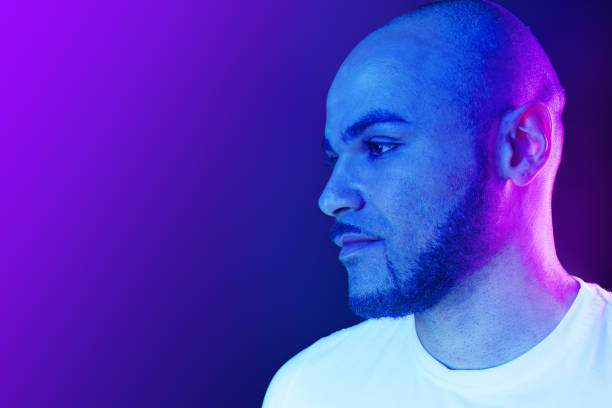 istock Serious thoughtful black guy portrait in neon light 1284224369