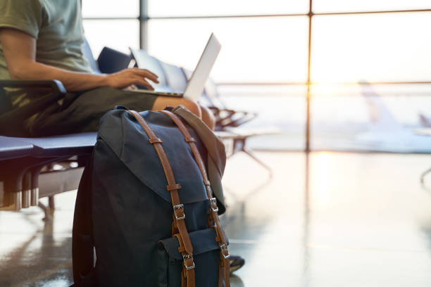 istock asian man waiting for departure at airport working using laptop computing 1284224910