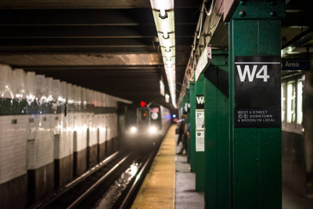 A train approaching the platform at West 4th Street subway station in Manhattan, New York City stock photo