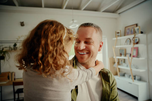 istock Happy man holding daughter in hand while playing at home 1284225336