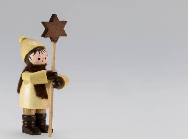 Traditional christmas carolers, star singers as wooden figures from Erz Mountains Germany Carol singers wood figure against gray background and place for text erzgebirge stock pictures, royalty-free photos & images
