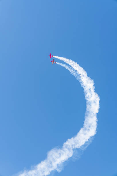 istock Vintage biplane does loop stunt with smoke trails. old airplane 1284227167