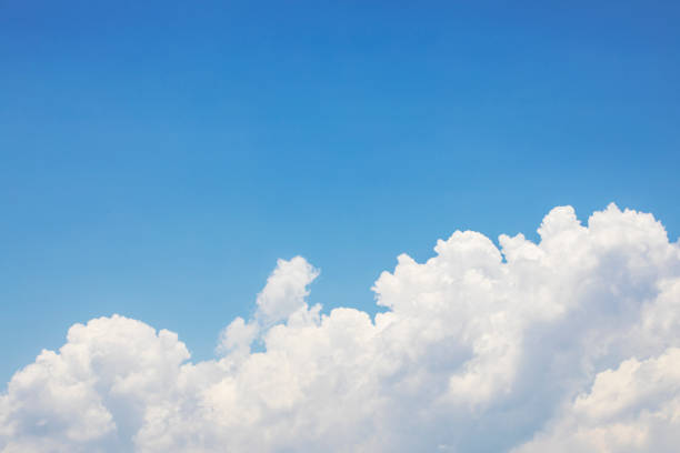 istock Blue sky background and white clouds soft focus, and copy space 1284229829