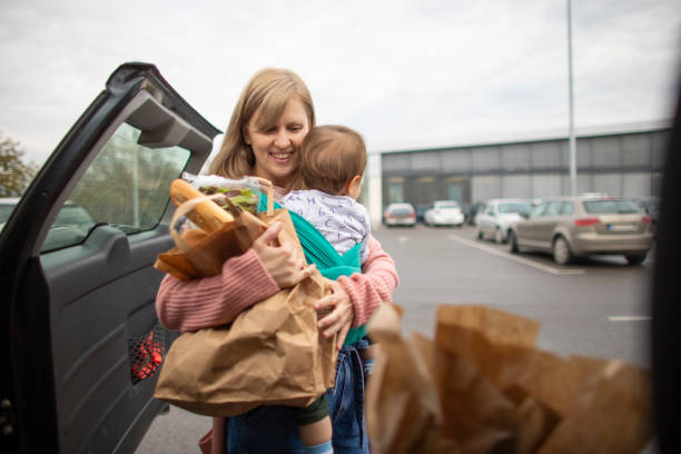 istock Single mother at grocery shopping with baby 1284230248