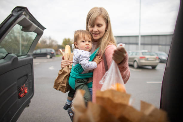 istock Single mother at grocery shopping with baby 1284230258
