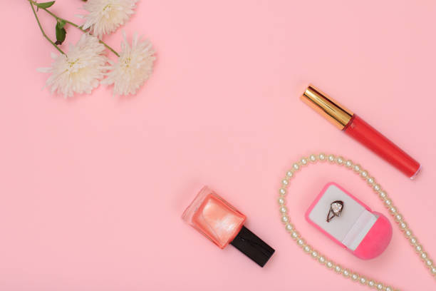 istock Box with ring and women cosmetics on a pink background. 1284230941