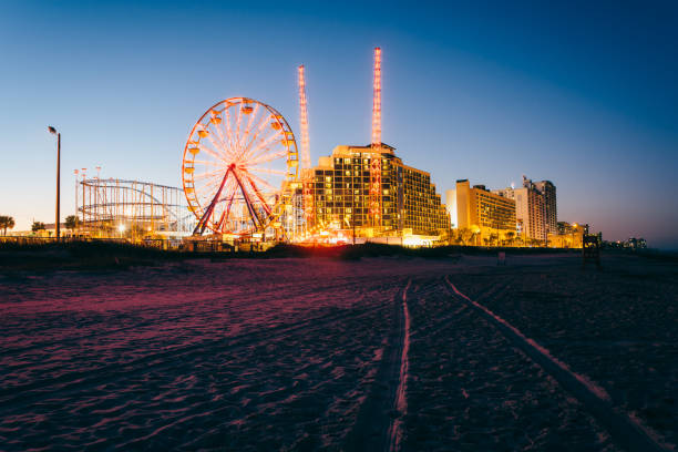 Tire tracks on the beach, rides and hotels at night, in Daytona Beach, Florida Tire tracks on the beach, rides and hotels at night, in Daytona Beach, Florida daytona beach stock pictures, royalty-free photos & images