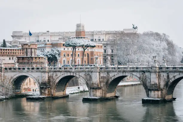 Ponte SantAngelo and the Tiber River in the snow, in Rome, Italy