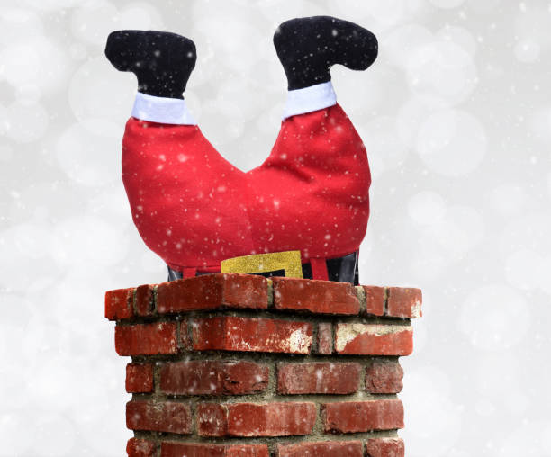 istock Santa Claus stuck upside down in a chimney over a silver bokeh 1284232442