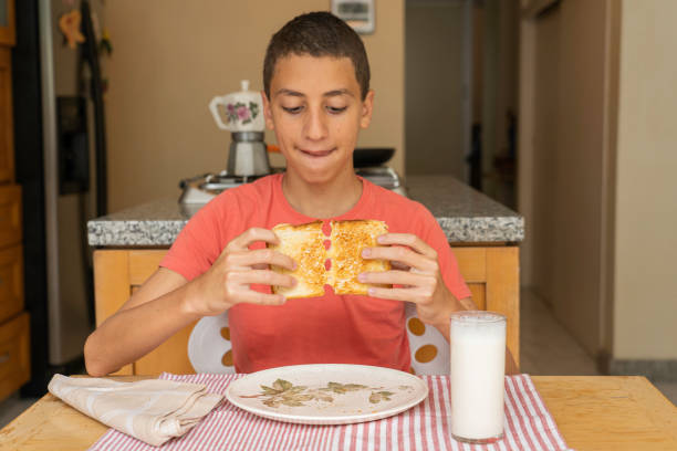istock Boy about to eat melted cheese sandwich 1284234188