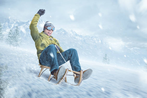 istock Smiling man riding on a sled in winter 1284234551