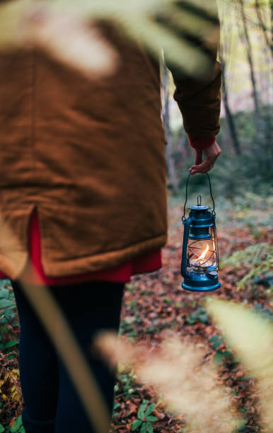istock Woman Walking With An Old Blue Lantern In Her Hand 1284237072