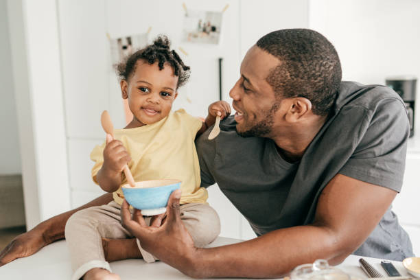 istock Dad and toddler eating snacks 1284237386