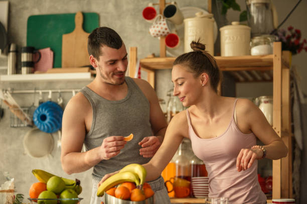 istock Young couple preparing breakfast together during lockdown days 1284238956