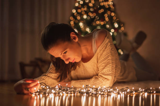 istock Woman arranging Christmas lights 1284241565