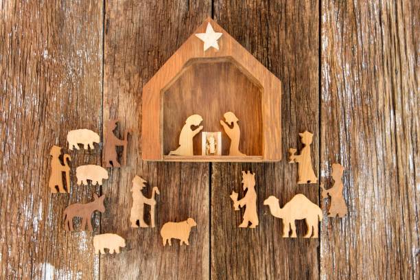 christmas nativity scene rustic nativity scene with wood figures on a wood background shepherd sheep lamb bible stock pictures, royalty-free photos & images