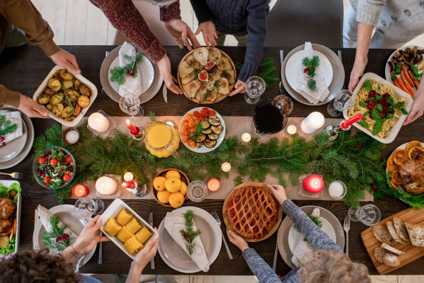 top view of hands of family members holding plates with homemade food - christmas table imagens e fotografias de stock
