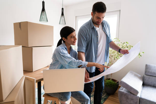 istock Young couple looking at house plans 1284242505