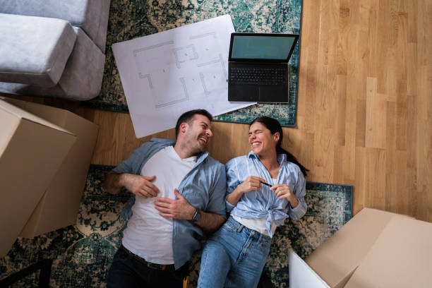 istock Top view of a young couple laughing while lying on the floor 1284242533