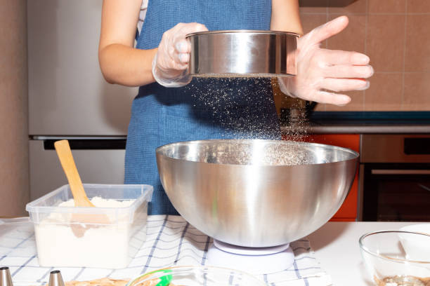 istock Sifting flour using a metal sieve into a bowl. Cooking process. 1284243107