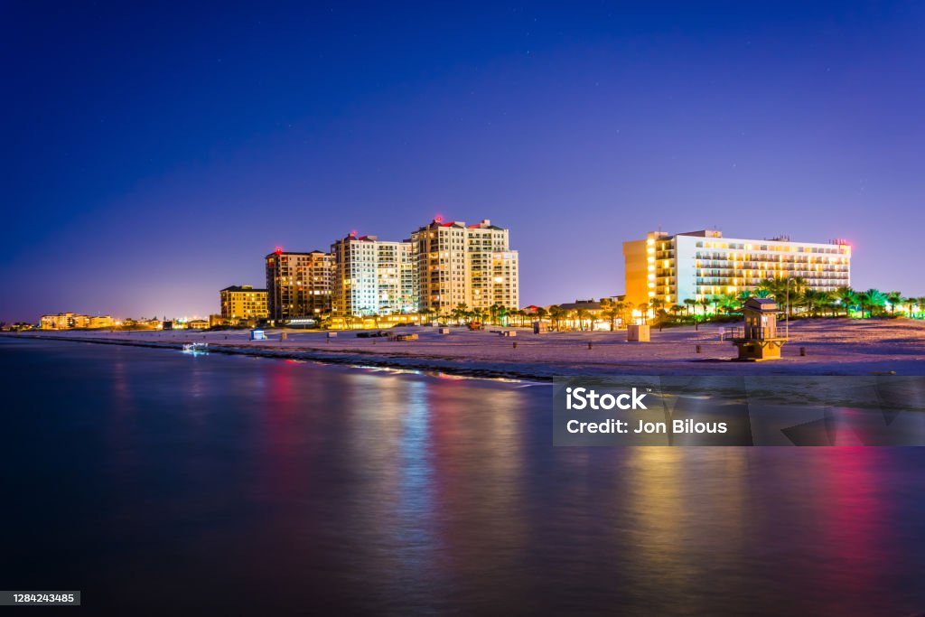 View of beachfront hotels and the beach from the fishing pier at night in Clearwater Beach, Florida Clearwater - Florida Stock Photo