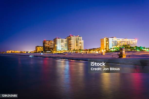 View Of Beachfront Hotels And The Beach From The Fishing Pier At Night In Clearwater Beach Florida Stock Photo - Download Image Now