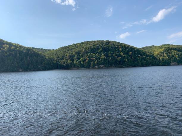 istock Green hills on the river 1284243619