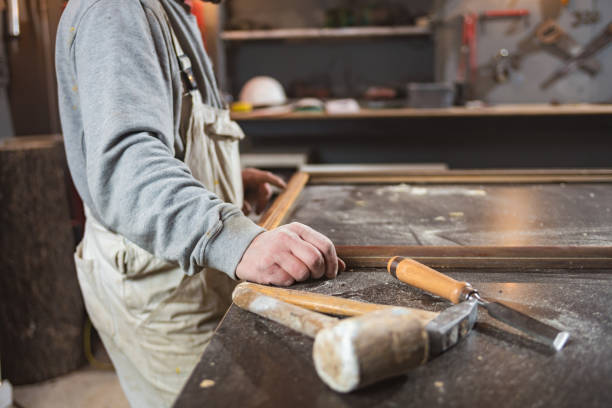 istock Male carpenter working on old wood in a retro vintage workshop. 1284244948