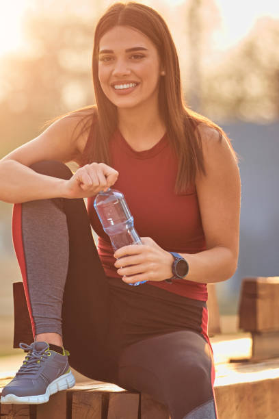 istock Modern young woman making pause after jogging / exercise. 1284245008