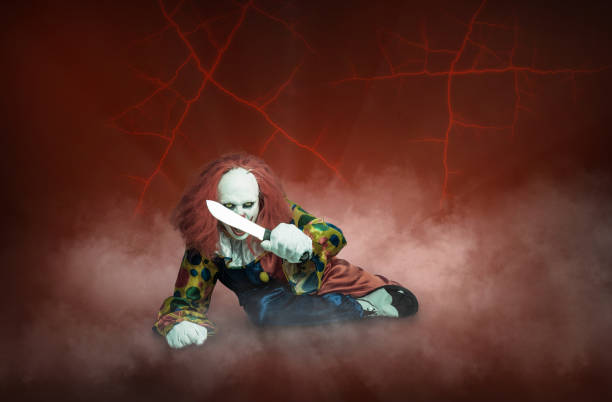 istock scary clown with knife on a abstract red background 1284246118