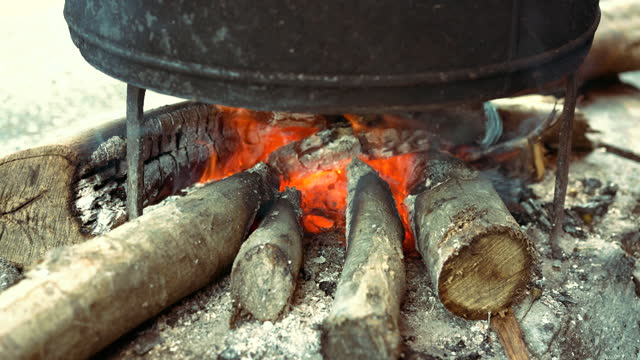 Cooking in a Traditional Cauldron Over Wood Fire