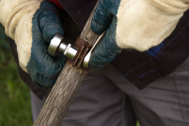 istock Men's hands in gloves are twisted with special nut carpenter. 1284248822