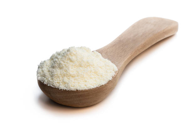 istock Full fat powdered milk in wooden spoon isolated on white 1284248911