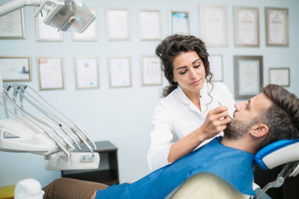 istock Handsome young Caucasian man visiting a dentist's office 1284250270