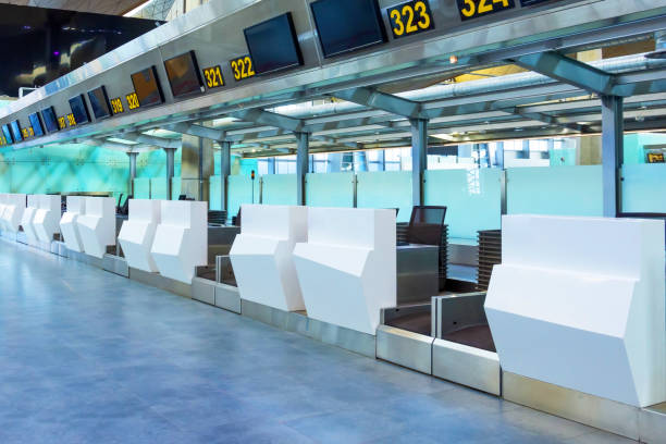 empty check-in desks for drop off baggage with paths canceled at the airport terminal. - airport airport check in counter ticket ticket machine imagens e fotografias de stock